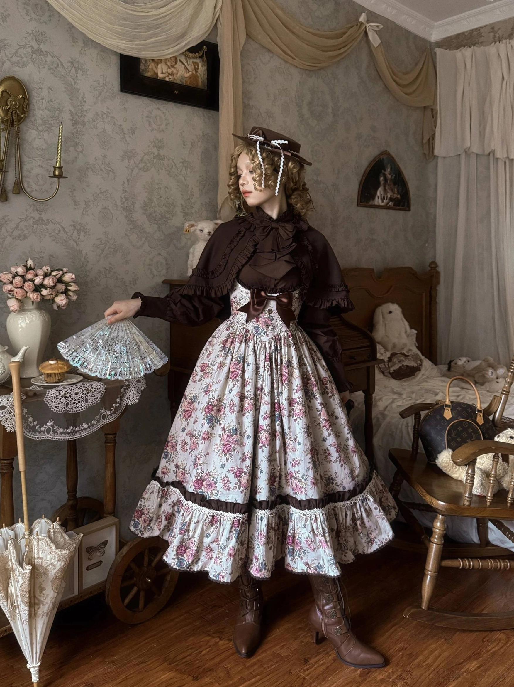 Floral Reverie Lolita dress side view on model wearing brown long-sleeve inner vintage hat and leather boots in bedroom setting