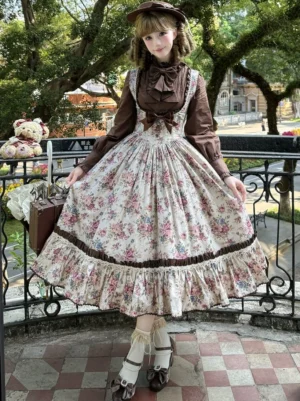 Floral Reverie Old School Lolita Jumper Skirt dress worn by model in outdoor vintage setting with brown coordinating top and lace hem details