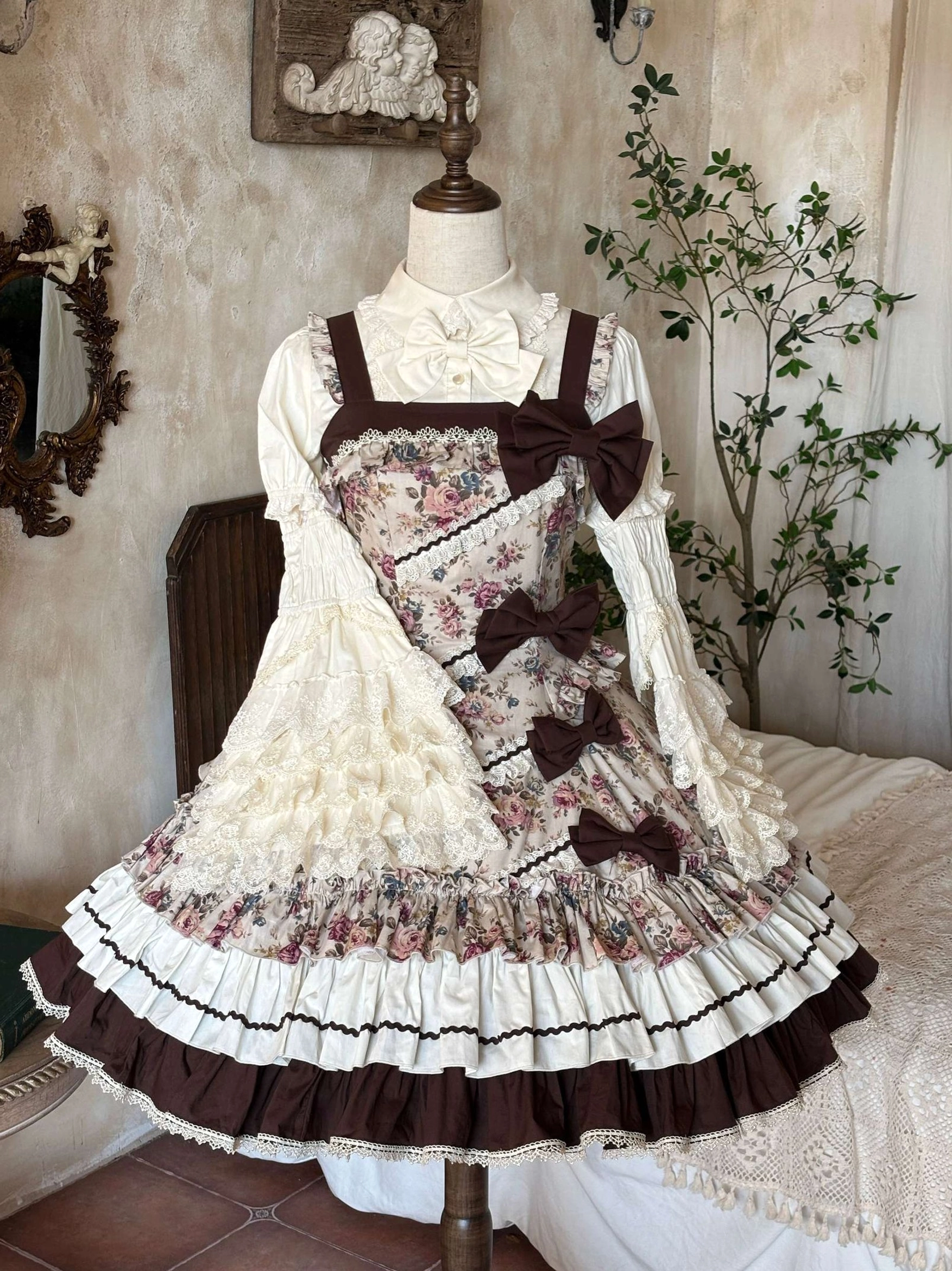 Floral Reverie vintage Lolita JSK dress on mannequin displaying brown and ivory color blocking detachable front bows and multi-layered ruffled skirt
