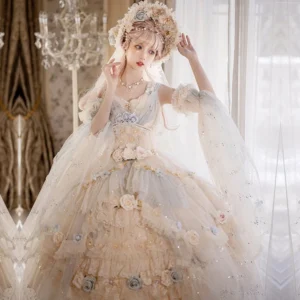Flower Spirit Lake Blue Lolita Jumper Skirt full front view with model adjusting elaborate flower crown veil, detachable sheer cape sleeves, sparkly tiered floral skirt with cream and light blue tones in crystal chandelier luxury room