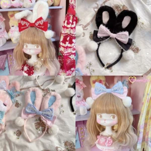 Flat lay collection of multiple fluffy bunny ear lolita hair clips with pink bows and pompom accents displayed on BJD doll flat lay