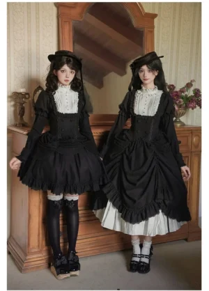 Full-body frontal view of classic black and white lolita dress set on two female models in vintage bedroom setting, featuring high ruffled collar, boned bodice, ruffled skirt with white underlayer, paired with boater hats, thigh-high socks, and platform mary jane shoes