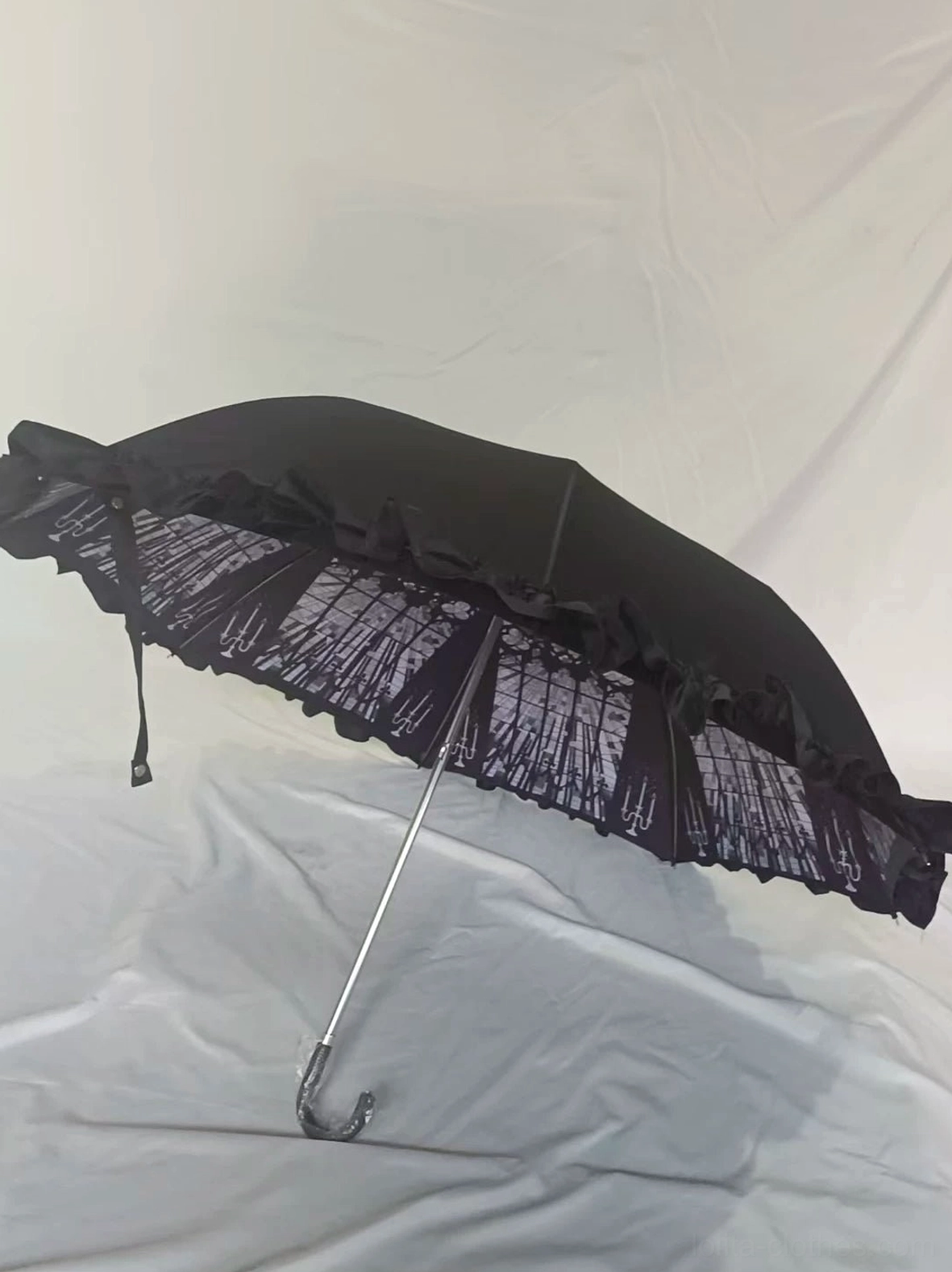 Compact folded foldable Lolita parasol measuring 39 cm in length demonstrating portable two-fold design for travel and conventions, flat lay showing closed position