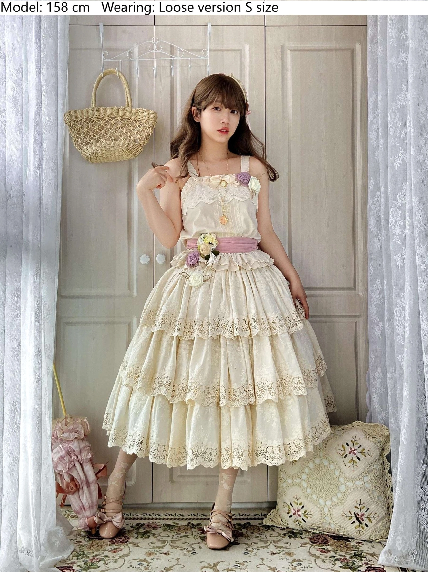 Cream beige Forest Waltz loose-fit lolita slip dress with tiered lace hem, pink waist sash, floral brooch details, size S loose version on female model in bedroom with wooden door