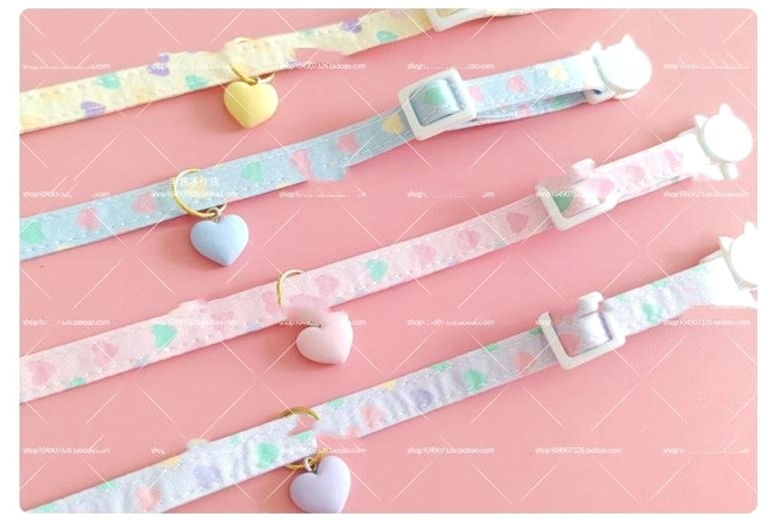 Four assorted pastel heart charm chokers collection flat lay showing varied color strap options and heart pendant designs lolita accessories set