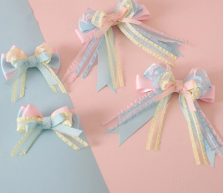 Four piece assorted pastel ribbon bow hair clips varying sizes sky blue pink bows yellow ribbon accents alligator clip fasteners