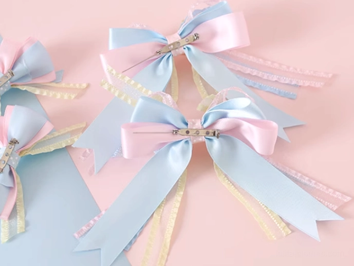 Four piece pastel satin ribbon bow hair clips large sky blue small pink bows yellow ribbon trims alligator clip fasteners top view