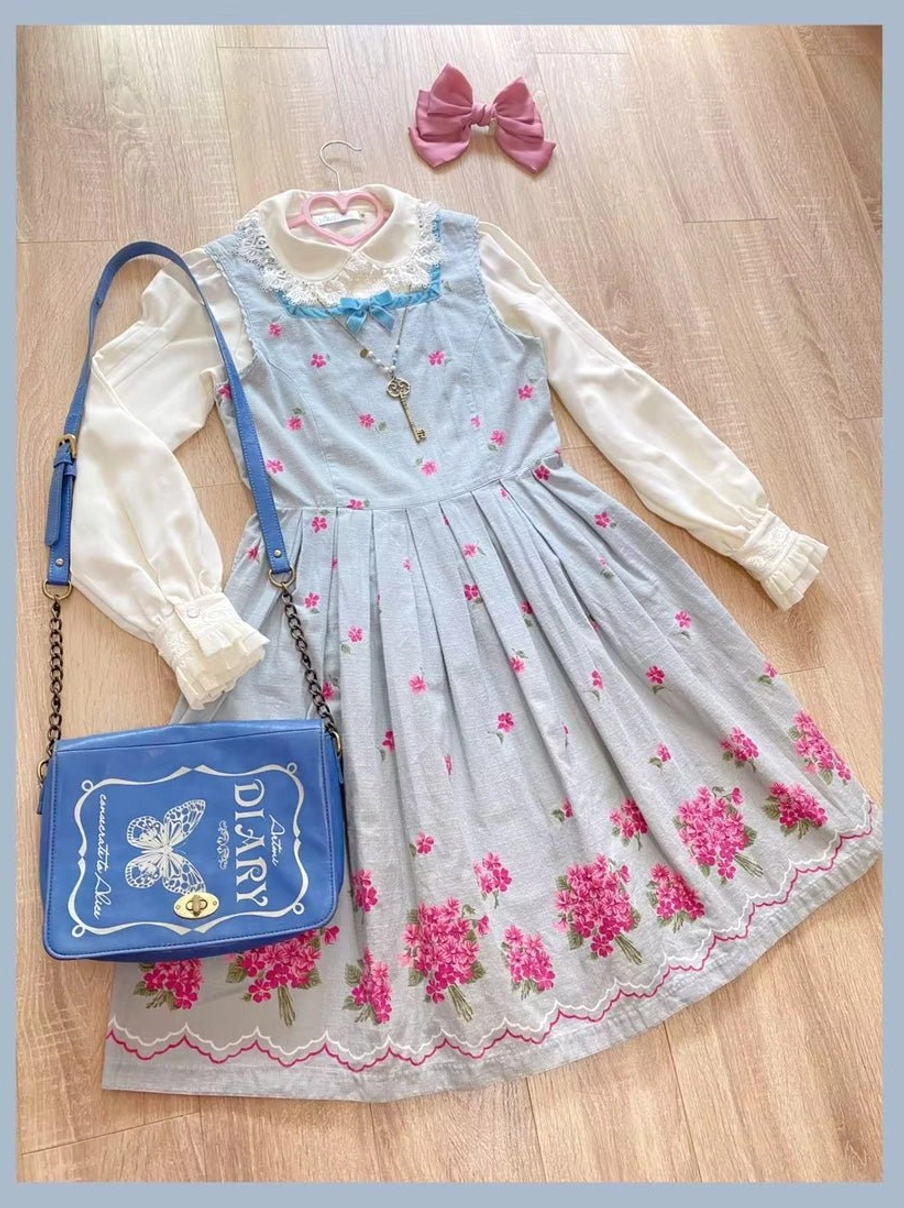 Full vintage Lolita outfit set featuring embroidered dress with shoulder bag and hair bow styled with matching key necklace on wooden floor flat lay