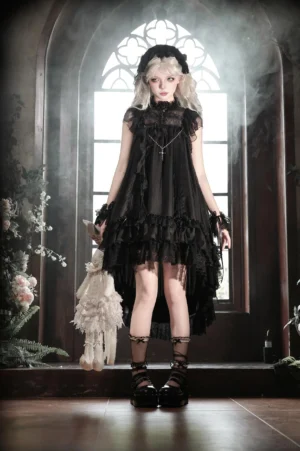Black gothic lolita OP dress with high ruffled collar, layered tulle skirt, and platform combat boots styled with wrist accessories