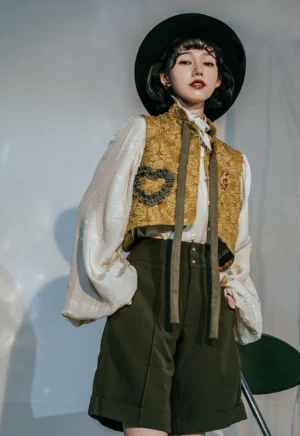 Gilded Age vintage Lolita three-piece suit front view - model wearing yellow jacquard vest with heart ruffles and dark green pleated skirt with lantern sleeves