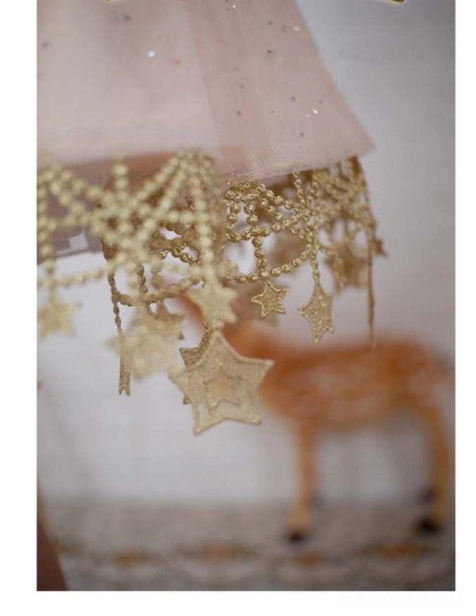 Close-up detail shot of gold beaded star lace trim with hanging star pendants on lolita petticoat hem