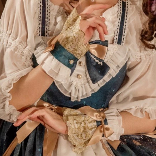 Model wearing gold embroidered lace lolita cuffs with champagne satin bows paired with teal and white lolita dress outfit coordination