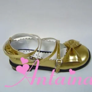 Gold glossy patent leather handmade lolita tea party shoes featuring scalloped collar, adjustable ankle straps with metal buckles, and front bow accent - side close-up view