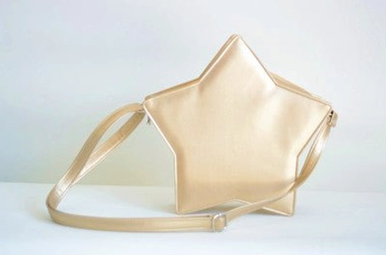 Champagne gold metallic star Lolita crossbody bag three-quarter side view, luxury Sweet Lolita style with matching golden shoulder strap and sleek silhouette