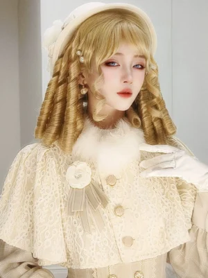 Side front three-quarter view of golden blonde roman curl lolita wig with tight spiral curls, paired with vintage cream lolita suit, white top hat, pearl drop earrings, and fluffy fur neck trim