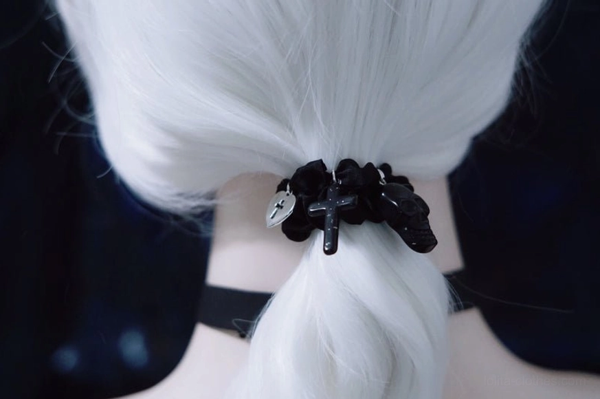 Gothic hairband close-up showing black satin material and silver pendant details