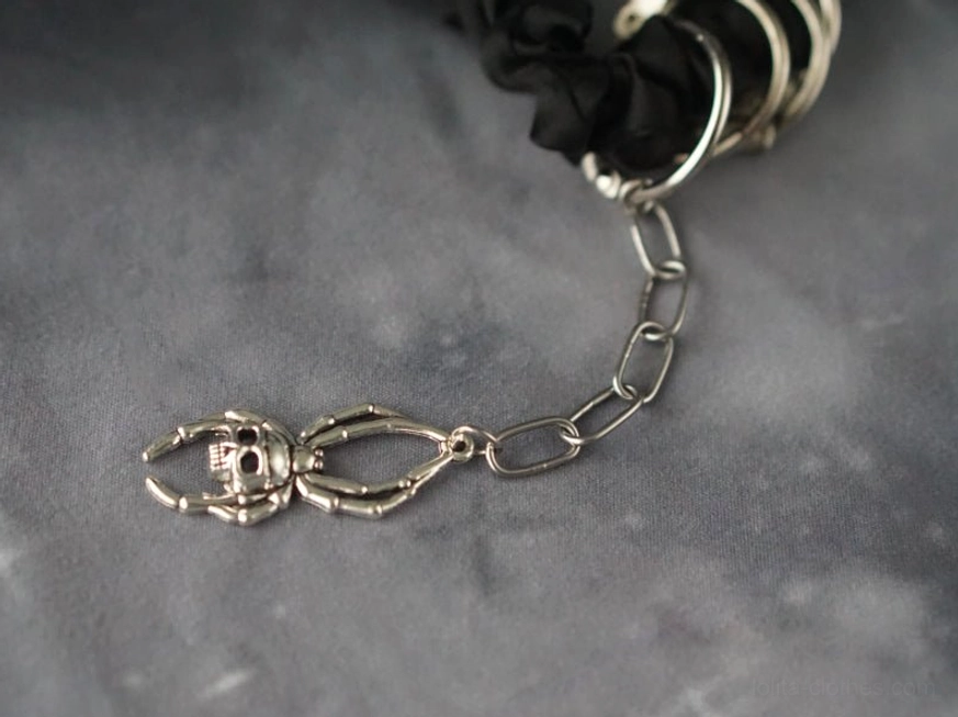 Close-up detail of skeleton lobster clasp and metal chain gothic hair scrunchie hardware