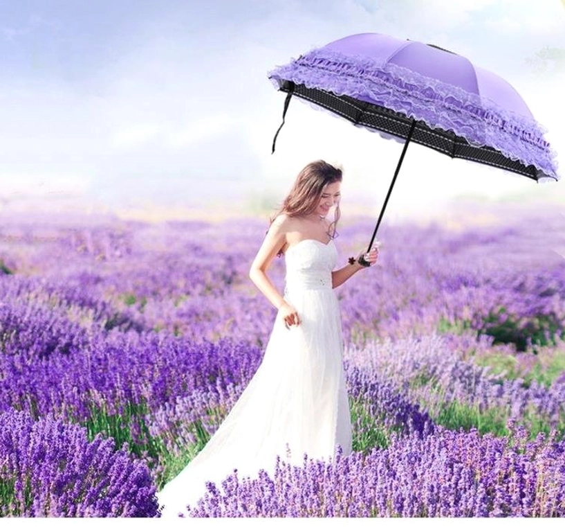 Dark colored parasol with gothic aesthetic displayed in moody lighting showing ruffled lace and elegant silhouette