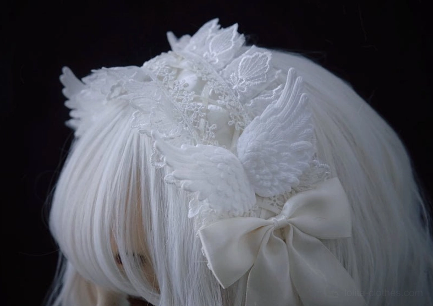 Lolita angel wings lace hairband back left three-quarter view on wig mannequin without full model, showing back bow and wing embellishments clearly