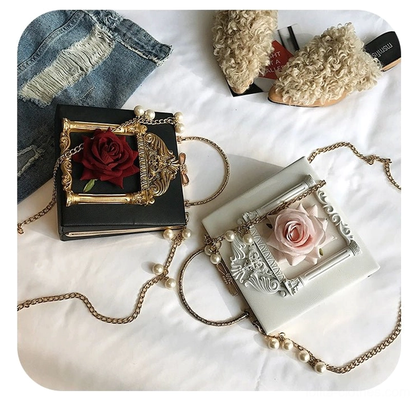 Two color variants of gothic lolita crossbody handbag showing red rose with gold baroque frame and pink rose with silver frame pearl decorated chain strap
