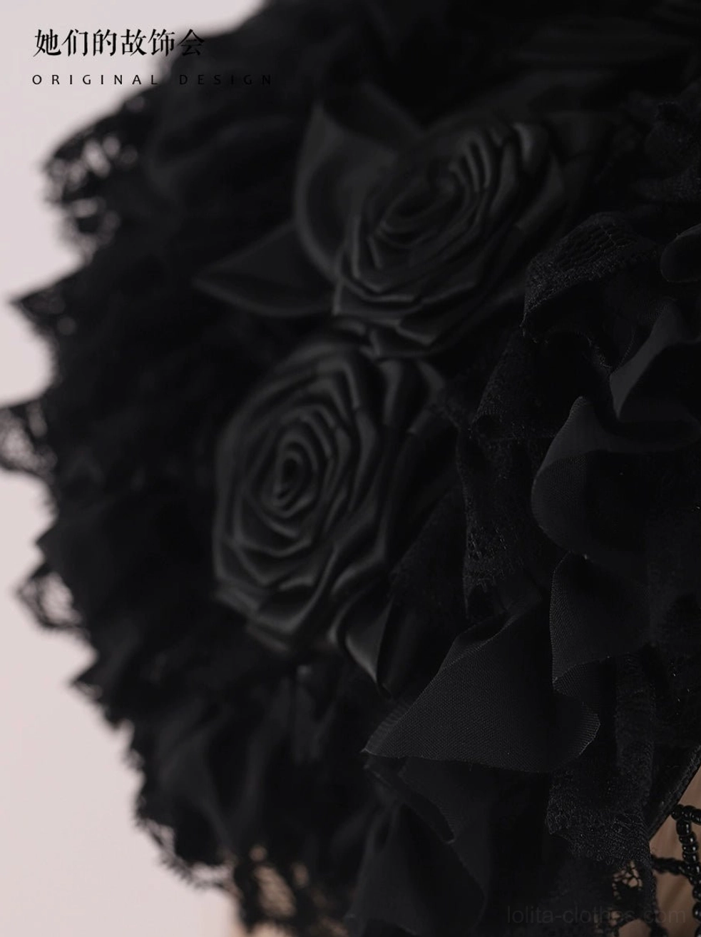 Extreme close-up macro detail of Gothic Lolita black bonnet hat featuring textured satin fabric roses, layered chiffon ruffled embellishments, and precise handmade stitching craftsmanship