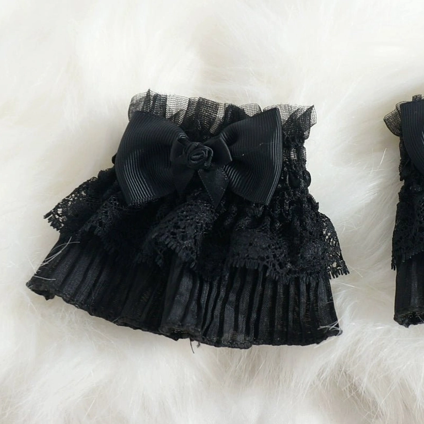 Close-up detailed view of Gothic Lolita black lace wrist cuff without cross pendant, highlighting layered lace ruffles and black satin bow with fabric rose