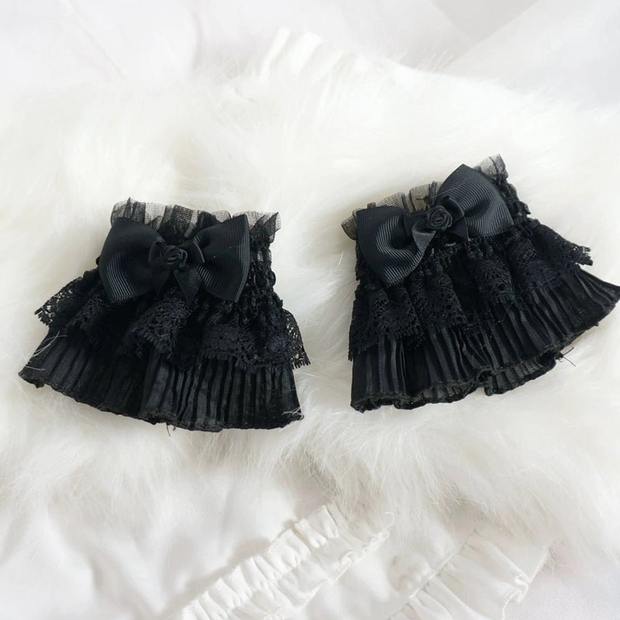 Gothic Lolita black lace wrist cuffs without cross pendant, showing elegant ruffle layers, bow and rose detail from angled perspective
