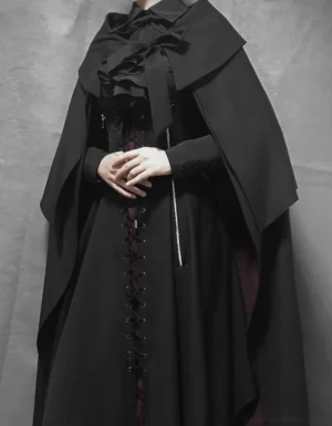 Gothic Lolita black and red cape ensemble with asymmetrical JSK jumper skirt dramatic front three-quarter view model wearing full outfit