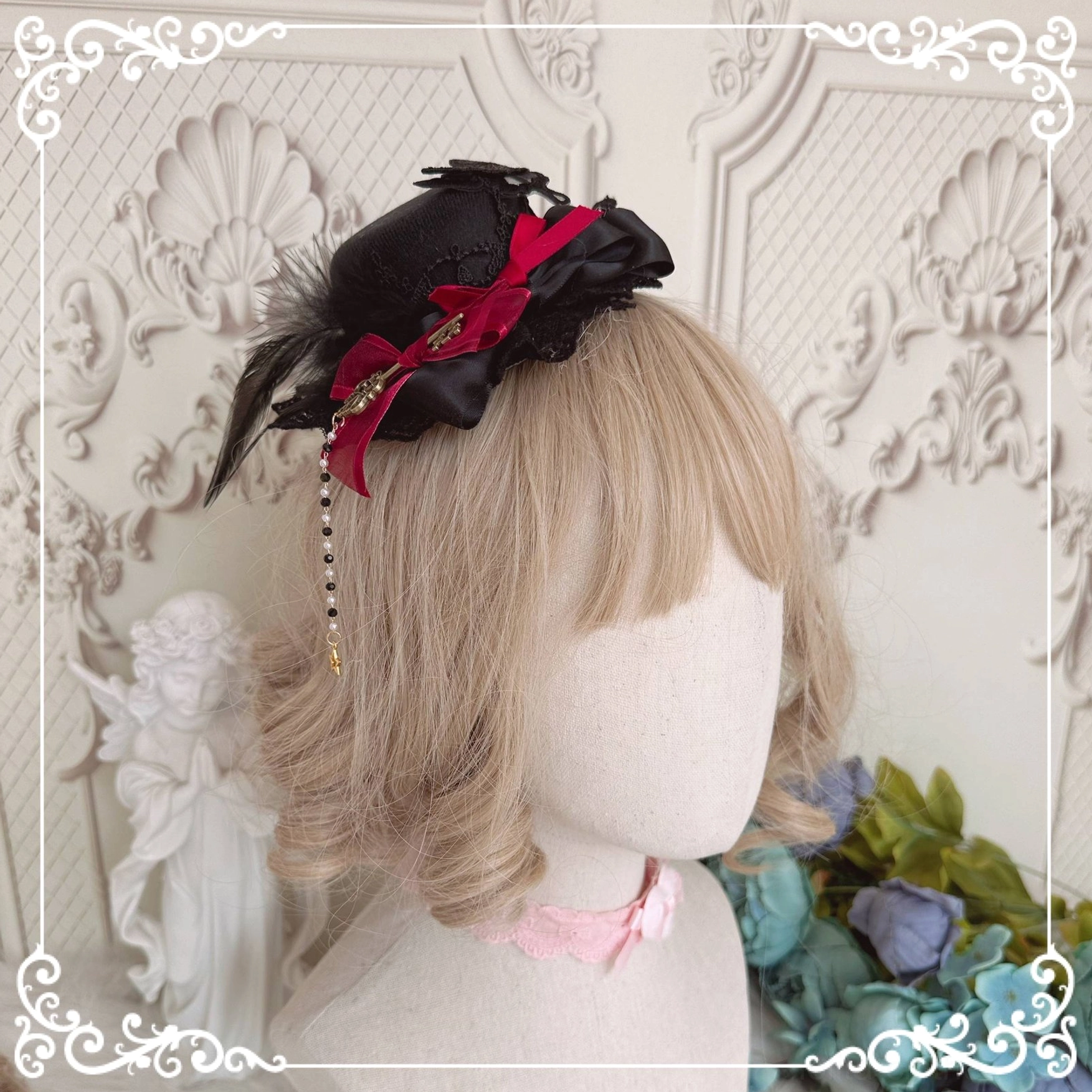 Gothic Lolita black mini top hat accessory standalone detail view showing feather trim, satin ribbon bow and tassel charm embellishment quality