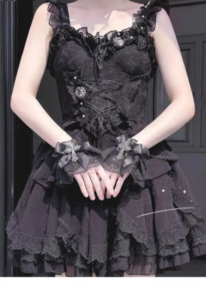 Gothic Lolita black wrist cuffs with silver cross embellishment and lace ruffles on model in full goth coordinate