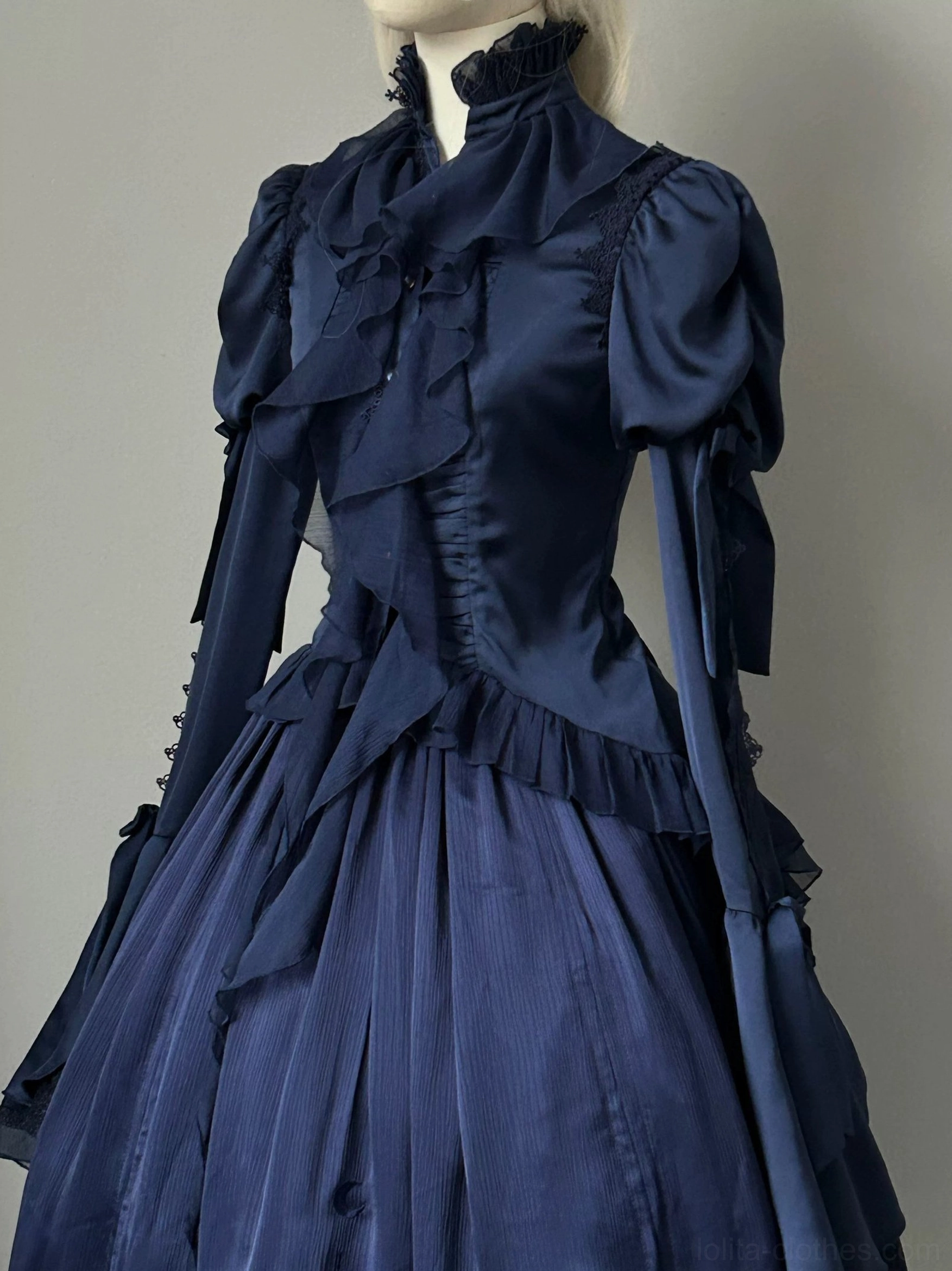 Navy blue gothic lolita blouse back view showing lace-up corset fastening, back vent design, and swallowtail flounce hem draping and movement