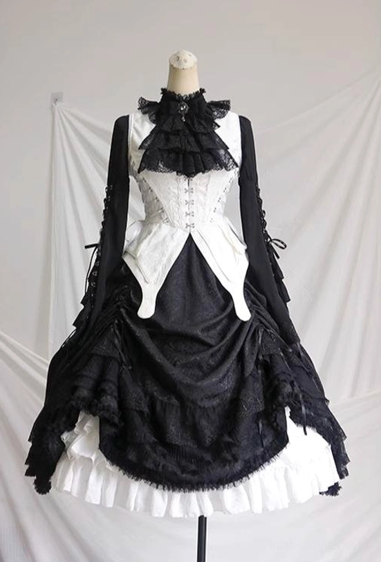 Gothic lolita butterfly-pattern lace cuff detail on blouse sleeve showing printed butterfly motif, refined lace trim construction, delicate pattern work, and artistic design element