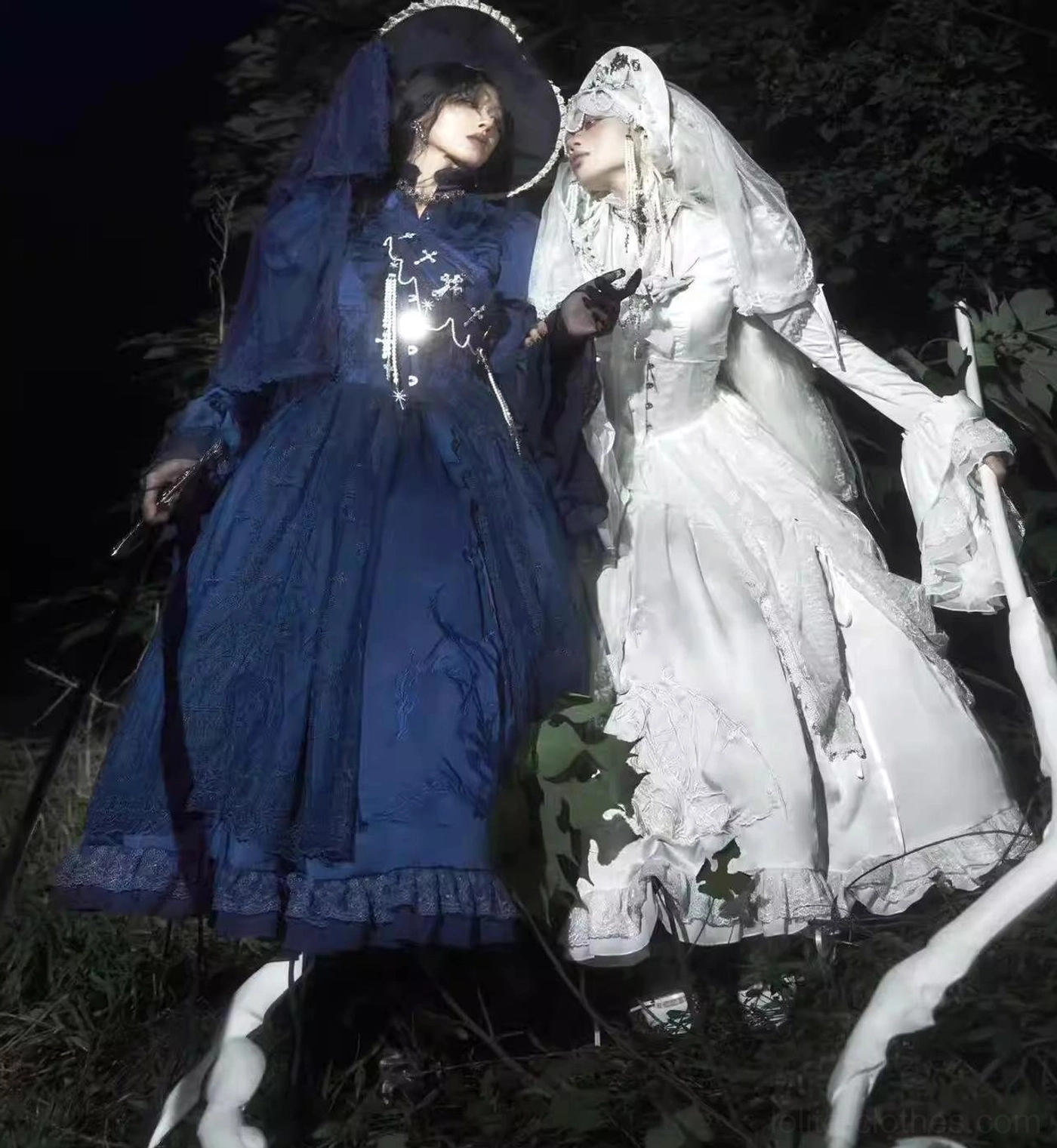 Dark blue gothic lolita blouse care and storage display with included white inner camisole, showing maintenance recommendations and product presentation