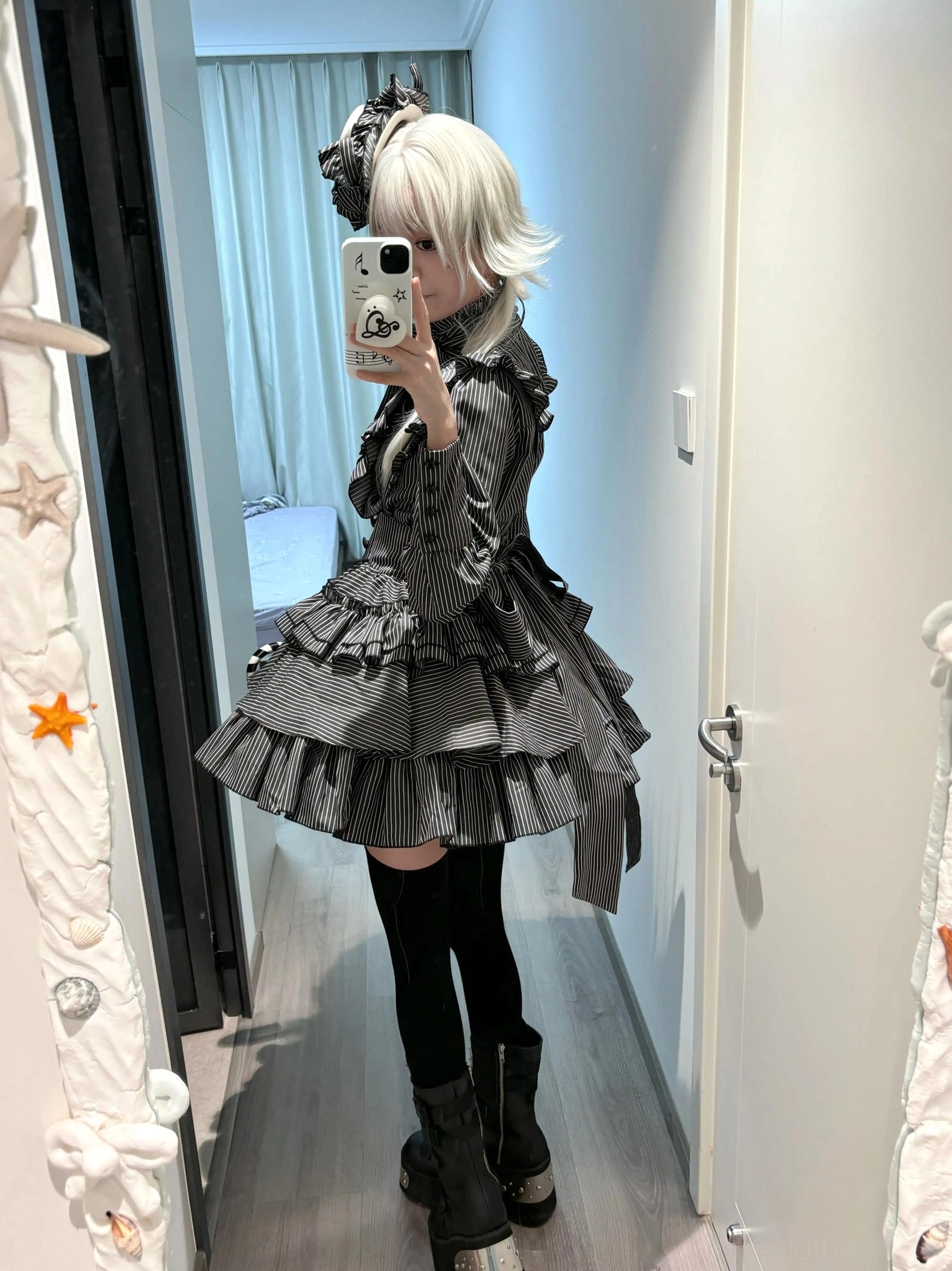 Gothic lolita striped blouse front bodice detail showing layered ruffles, semi-high collar construction, faux pearl buttons, and bow neckline centerpiece