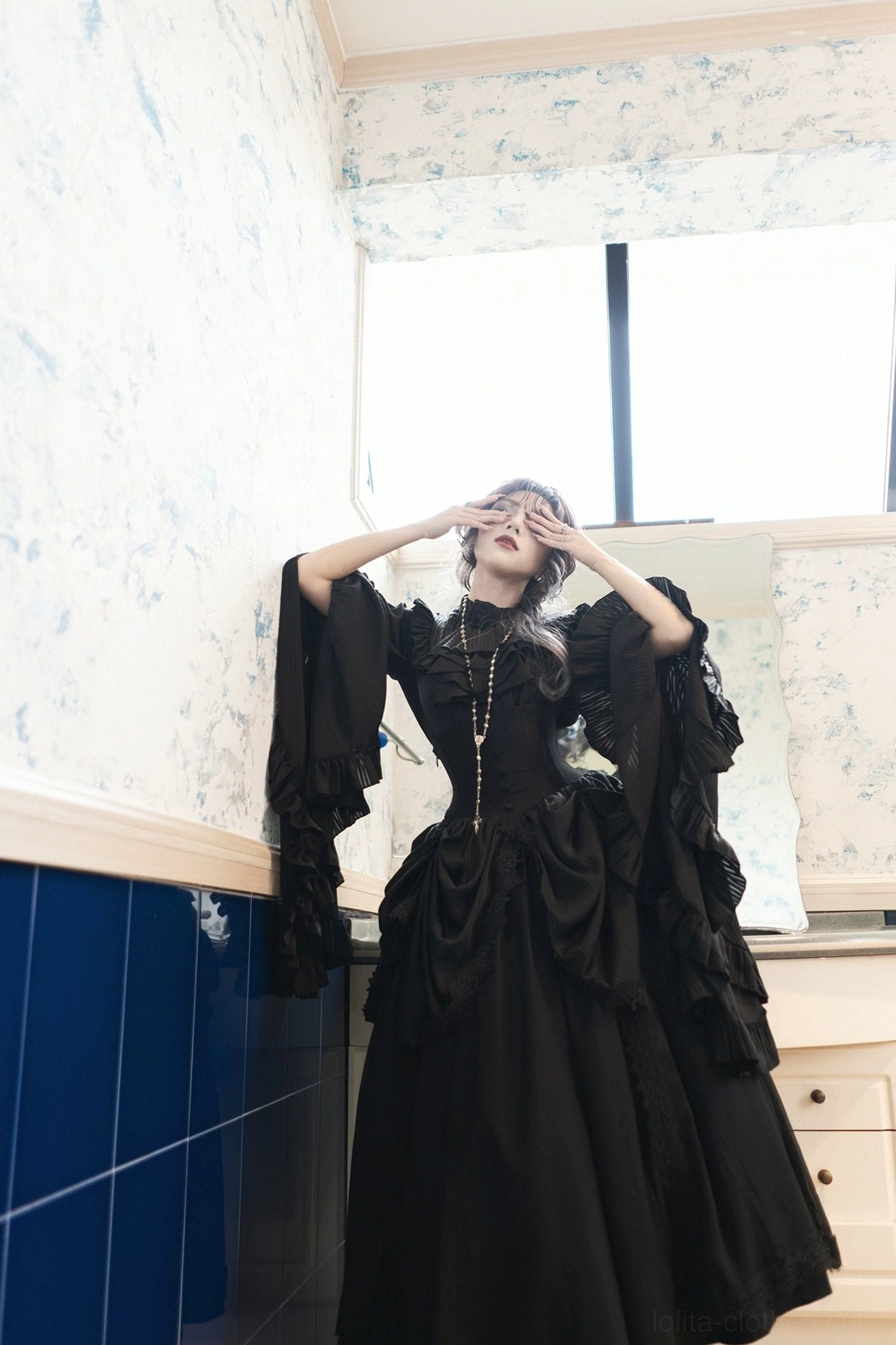 Gothic lolita blouse sleeve construction detail showing layered ruffled hems, princess sleeve architecture, and pleated fabric technique