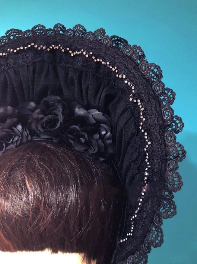 Close-up detailed view of black gothic lolita velvet bonnet showing intricate scalloped lace trim, hand-beaded brim edging, gathered velvet texture and satin flower ornaments