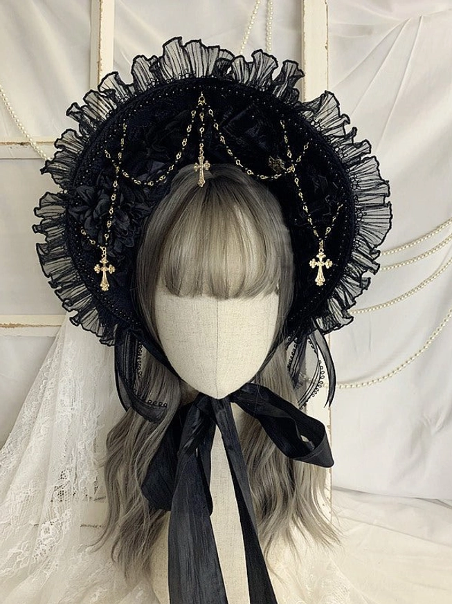 Gothic Lolita black bonnet headdress front close-up view with ruffled mesh brim, gold cross pendant chains, and black satin chin ties