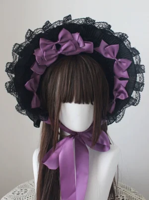Purple bow-tie style Gothic Lolita bonnet with ruffled black lace trim and long neck strap, shown on mannequin with brown hair wig