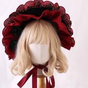 Gothic lolita bonnet front flat view showing two-tone red and black layered ruffled lace brim with wine-red neck tie straps on blonde mannequin