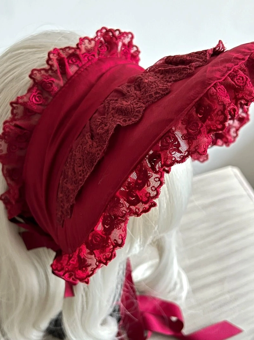Gothic lolita lace bonnet showing scalloped lace edge detail, embroidered fabric panel, premium material quality close-up
