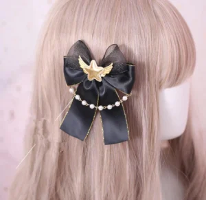 gothic lolita bow hairclip back view on blonde mannequin wig with black satin bow gold trim pearl chain star wing brooch