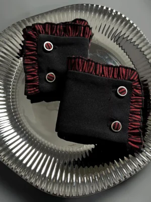 Gothic Lolita burgundy wine-red cuffs with pleated ruffled trim and decorative metal buttons flat lay detail