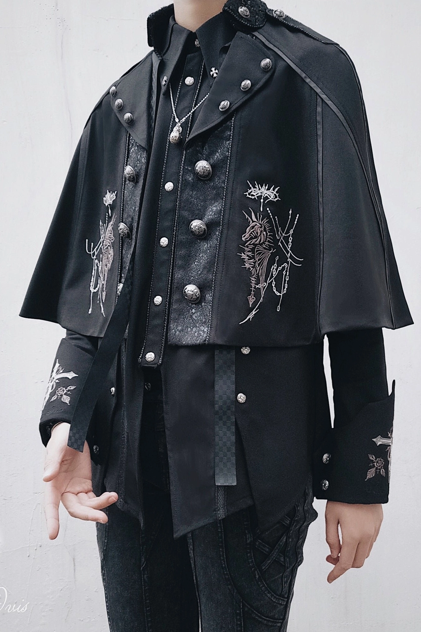 Black Gothic Ouji Lolita cape side profile half-body shot showcasing double-breasted metal buttons, leather front panel, and matching silver floral embroidery with dark gothic outfit coordination