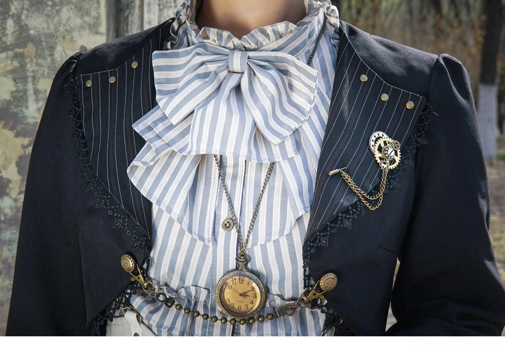 Chest up close up detail Gothic Lolita cardigan showing striped ruffled bow tie shirt metal studded jacket lapels heart brooch pocket watch chain