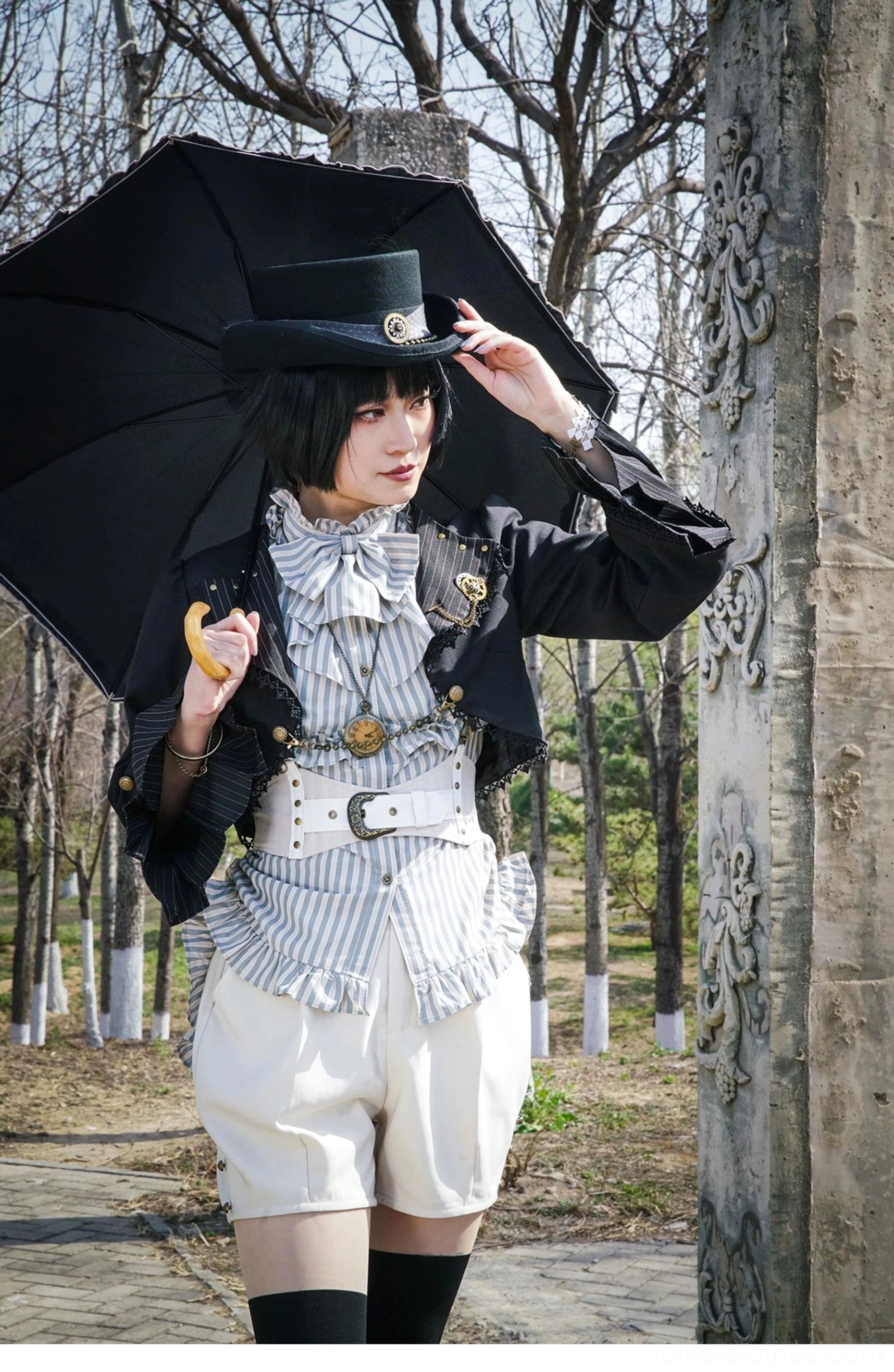 Medium full body front view model holding black umbrella wearing Gothic Lolita cardigan with pocket watch style accessories steampunk theme