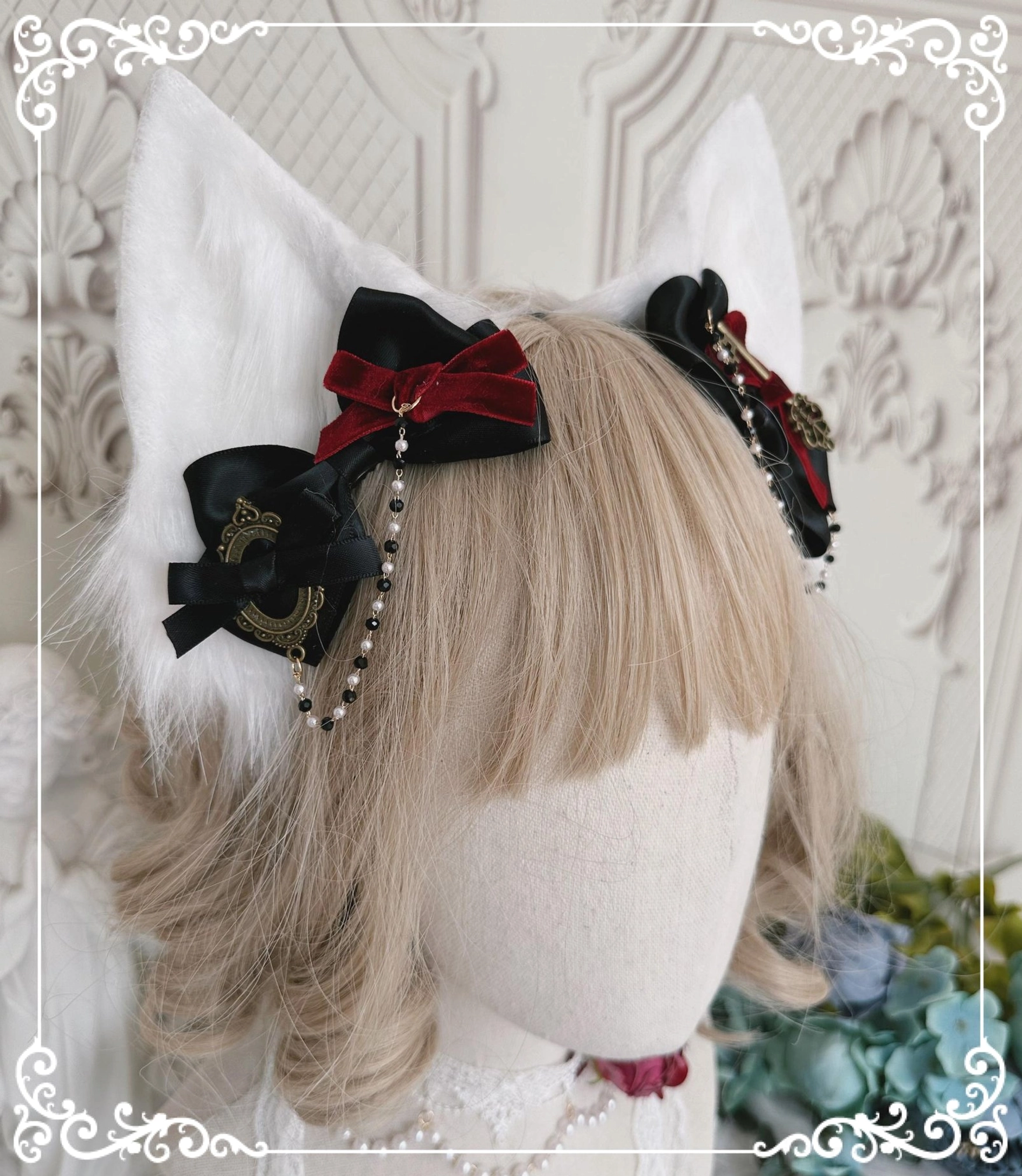 Gothic Lolita cat ear hair clips on blonde wig mannequin head featuring black and red satin bows with pearl chain tassels and white cat ear headdress