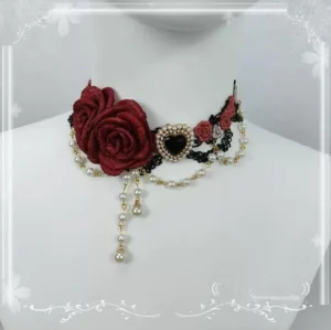 Victorian rose lolita choker necklace black burgundy with heart-shaped black gem center, gold pearl chain tassel, black lace collar detail on mannequin