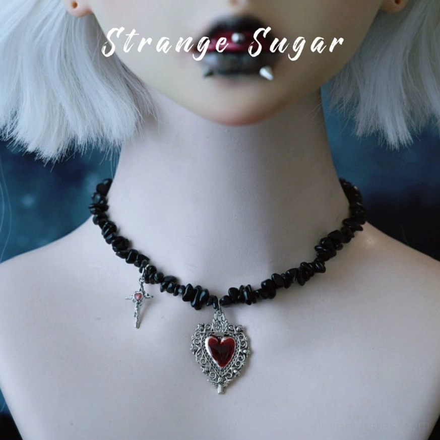 Gothic lolita choker with black obsidian chain worn by doll model with silver grey bob wig and dark makeup, dual pendants including small cross and vintage red heart locket