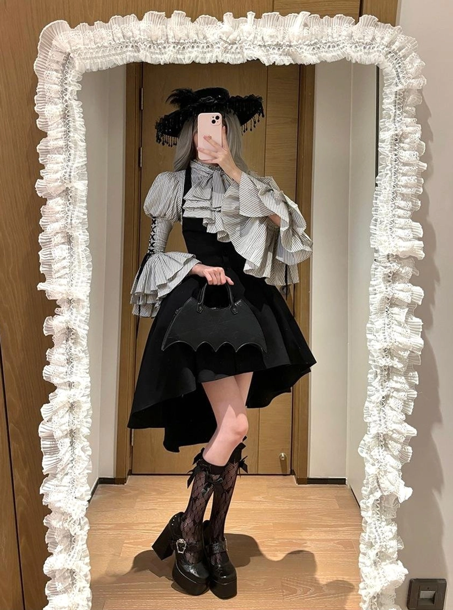 Full-length mirror selfie of complete Gothic Lolita daily outfit featuring striped blouse, black high-low skirt, gothic wide-brimmed hat, platform boots and bat-shaped leather handbag