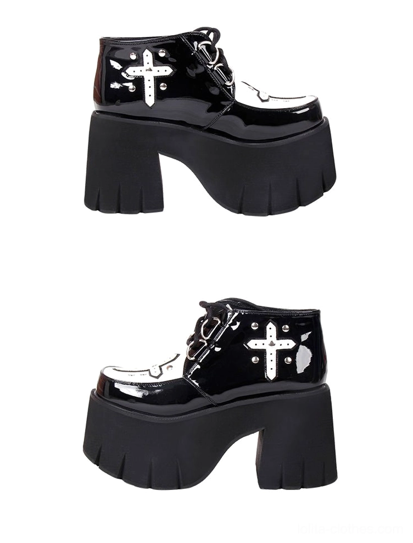 Two pairs of gothic lolita platform boots patent leather side three-quarter view glossy black upper silver cross applique thick platform block heels shiny finish